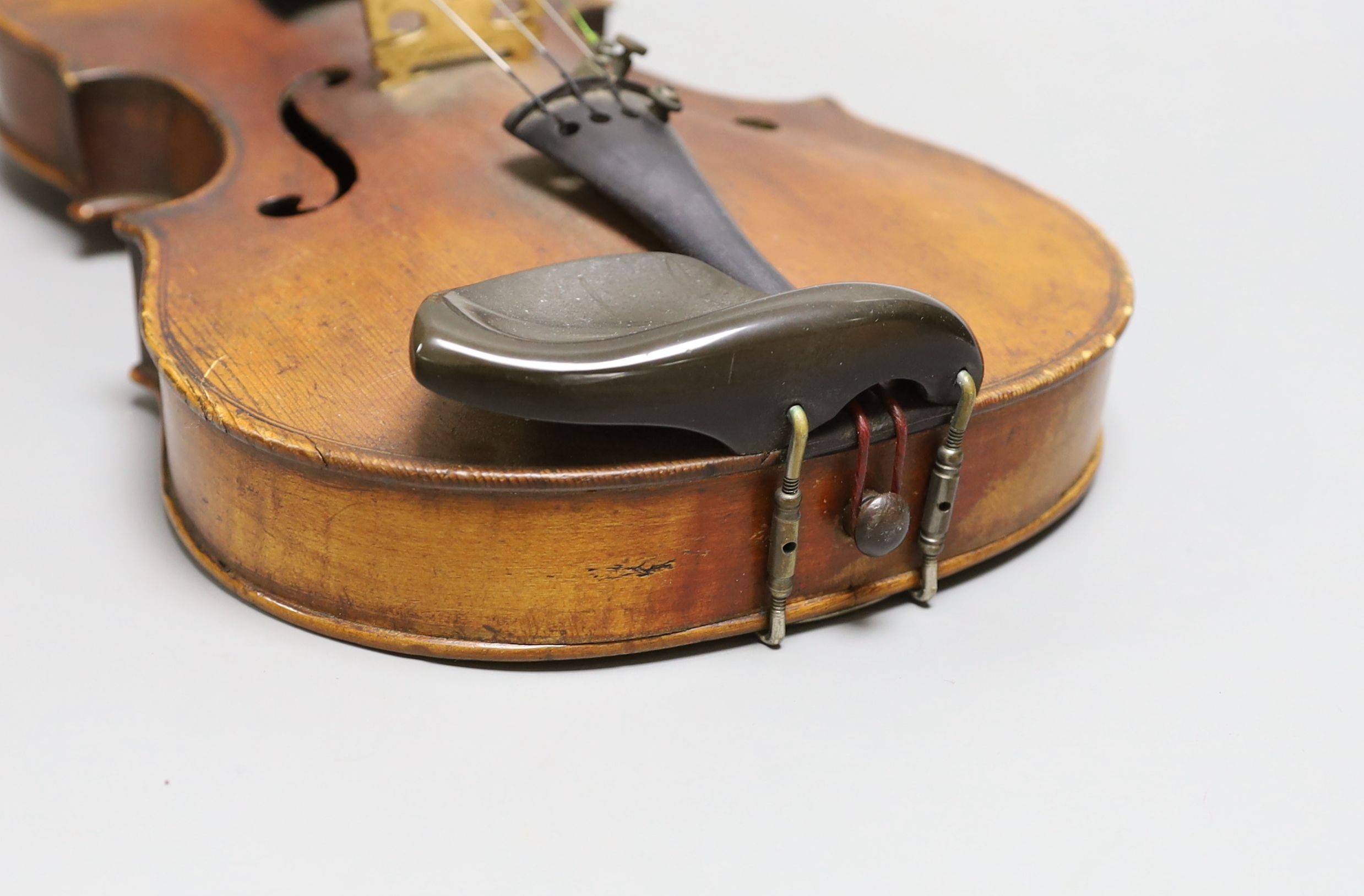 A 19th century violin with 14 inch 2 piece back, unlabelled, cased with silver mounted bow.